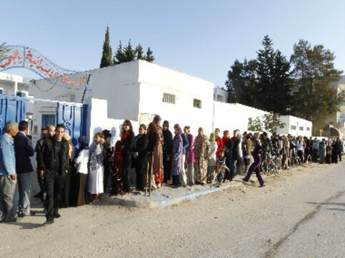 Tunisians begin voting in first Tunisians begin voting in first