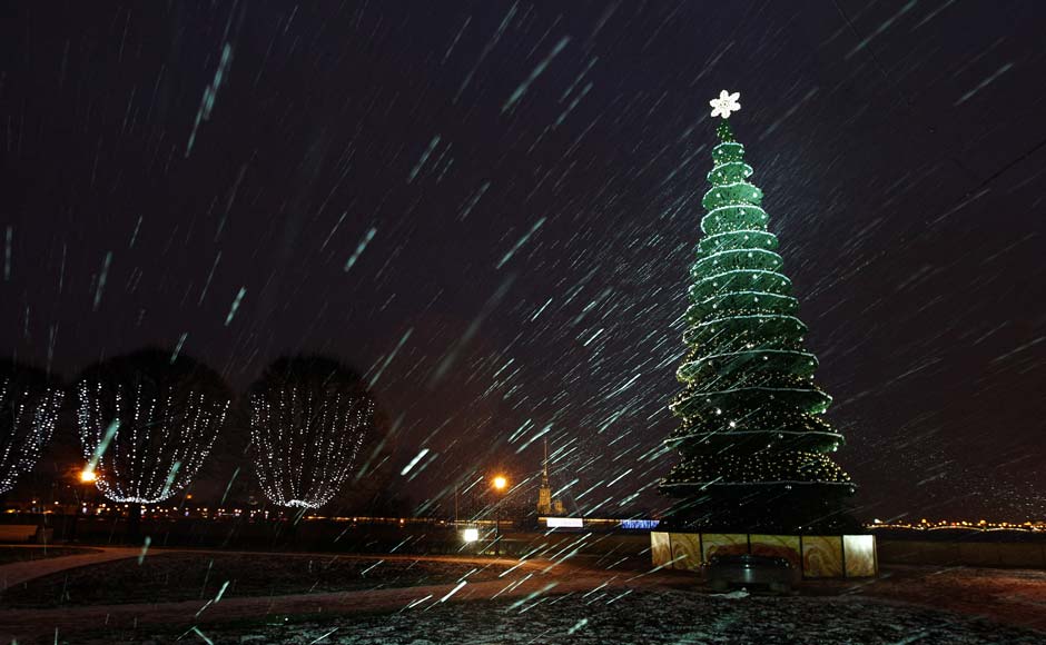 A lit Christmas tree is seen amidst snowfall in St Petersburg. Reuters A lit Christmas tree is seen amidst snowfall in St Petersburg. Reuters