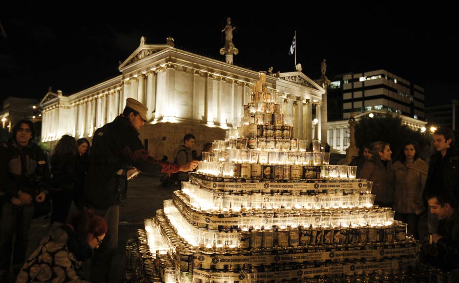 Volunteers make a Christmas tree with milk tin cans donated to the "Medecins Du Monde" non-governmental organisation, which will distribute them to the poor in Athens. Reuters Volunteers make a Christmas tree with milk tin cans donated to the "Medecins Du Monde" non-governmental organisation, which will distribute them to the poor in Athens. Reuters