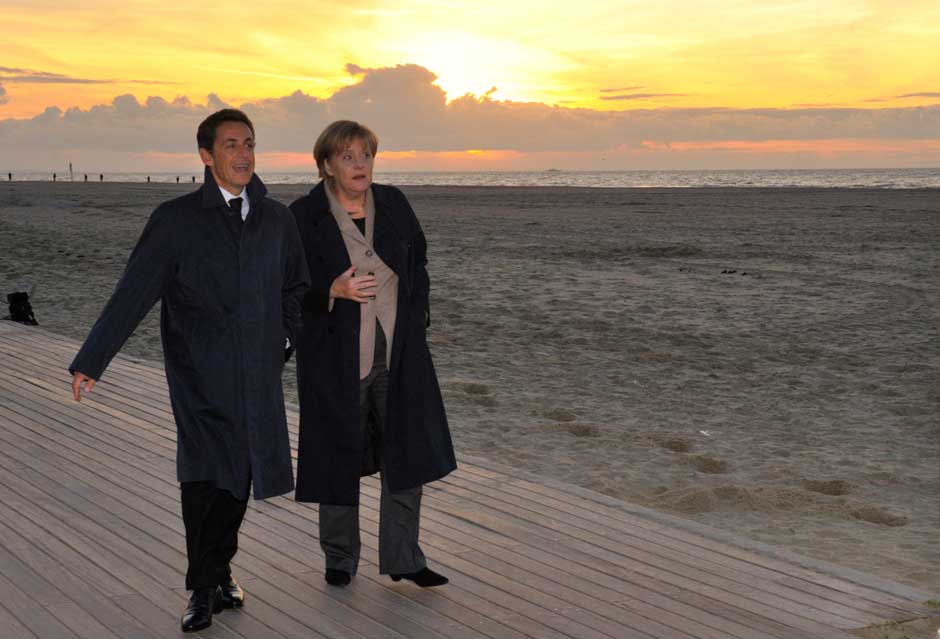 Oh if we could forget about that damned crisis and just enjoy the setting sun on the beach. AP Oh if we could forget about that damned crisis and just enjoy the setting sun on the beach. AP