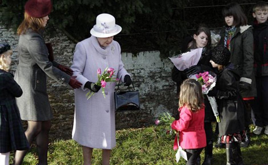 Britain's Queen Elizabeth II, receives flowers from children after she and other members of the royal family attended a Christmas Service at St Mary's church in the grounds of Sandringham Estate, the Queen's Norfolk retreat, England. AP Britain's Queen Elizabeth II, receives flowers from children after she and other members of the royal family attended a Christmas Service at St Mary's church in the grounds of Sandringham Estate, the Queen's Norfolk retreat, England. AP