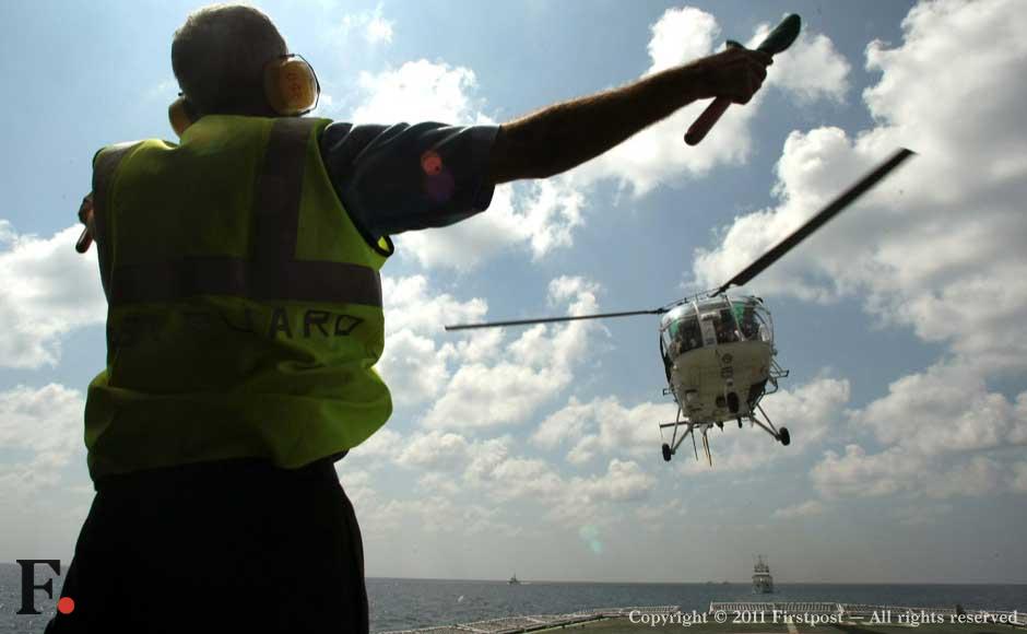 A Cheetah helicopter prepares to land on a Coast Guard carrier A Cheetah helicopter prepares to land on a Coast Guard carrier
