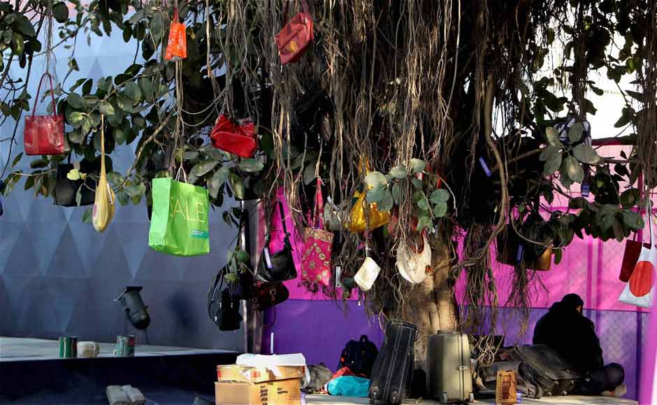 Visitors hang their belongings on a tree before entering India Art Fair. PTI Visitors hang their belongings on a tree before entering India Art Fair. PTI