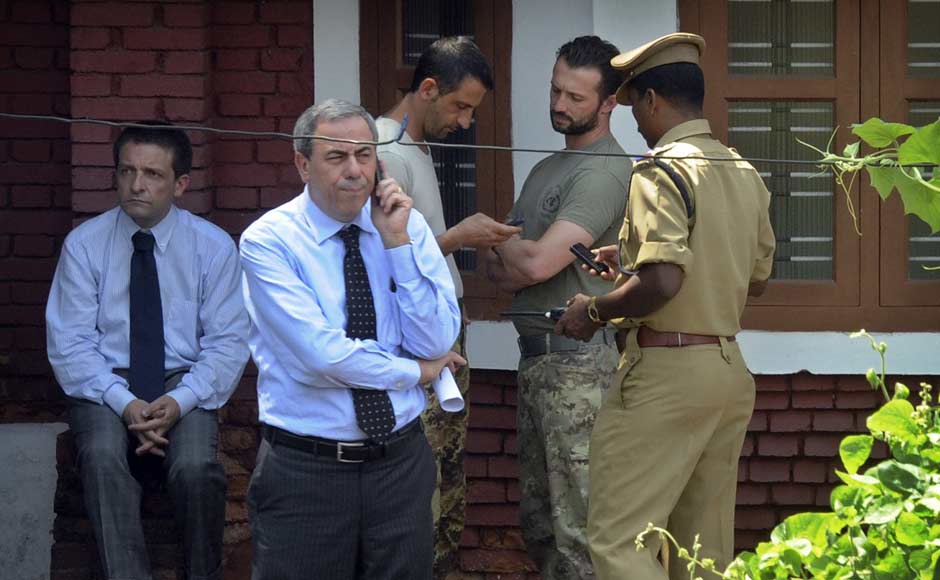 Members of the security crew of Italian cargo vessel, the Enrica Lexie Latorre Massimiliano, center left, and Salvatore Girone, center right, stand outside a government guest house where they were questioned by the Indian police officials for allegedly shooting two Indian fishermen to death in Kochi. AP Members of the security crew of Italian cargo vessel, the Enrica Lexie Latorre Massimiliano, center left, and Salvatore Girone, center right, stand outside a government guest house where they were questioned by the Indian police officials for allegedly shooting two Indian fishermen to death in Kochi. AP