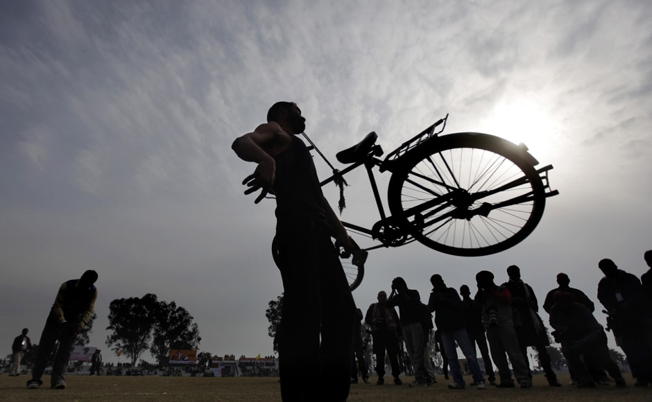 A villager lifts a bicycle with his teeth as he performs during the rural sports festival, on Saturday. AP A villager lifts a bicycle with his teeth as he performs during the rural sports festival, on Saturday. AP