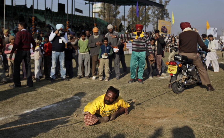 A physically challenged villager displays a feat of strength by stopping two motorbikes with ropes, during the Kila Raipur Sports Festival. AP A physically challenged villager displays a feat of strength by stopping two motorbikes with ropes, during the Kila Raipur Sports Festival. AP
