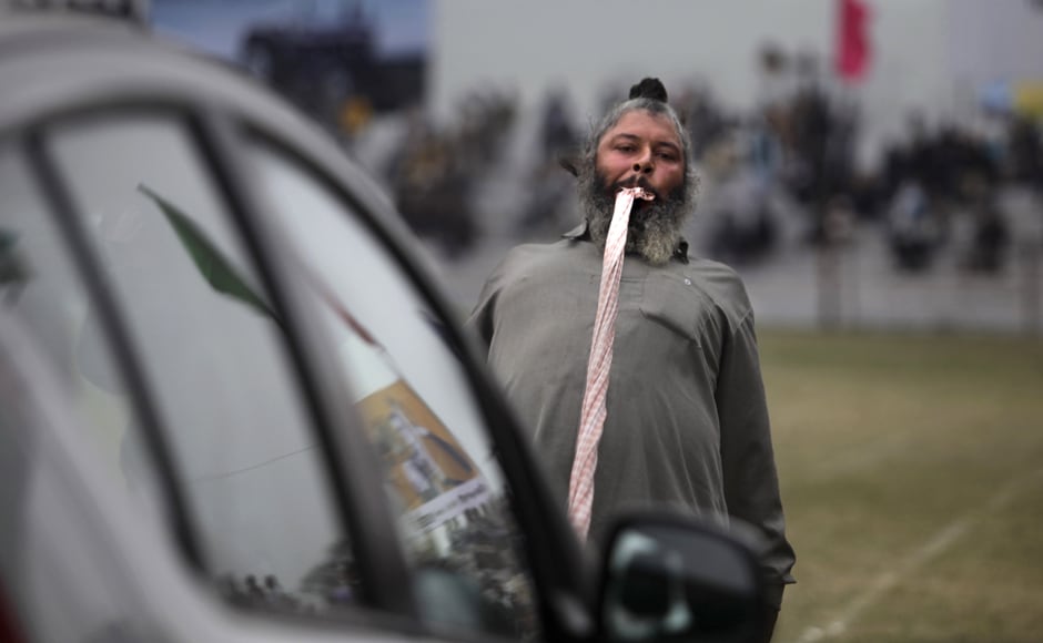 He's got teeth! An Indian villager pulls a car with his teeth during the "Indian Rural Olympics", in Kila Raipur, near Ludhiana. AP He's got teeth! An Indian villager pulls a car with his teeth during the "Indian Rural Olympics", in Kila Raipur, near Ludhiana. AP
