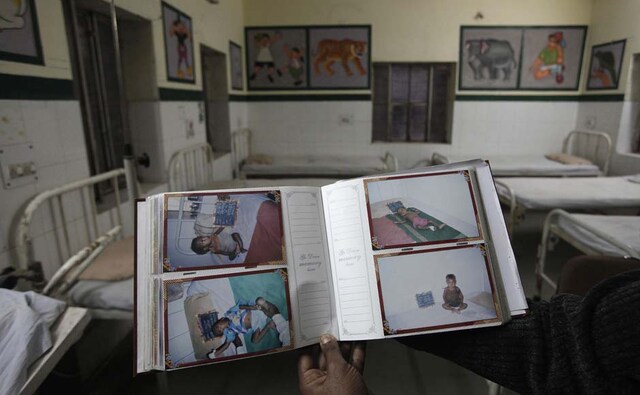 A hospital staff member shows pictures of malnourished children who were cured in a government hospital in Shahbad village in Baran district in the northwestern state of Rajasthan. Reuters A hospital staff member shows pictures of malnourished children who were cured in a government hospital in Shahbad village in Baran district in the northwestern state of Rajasthan. Reuters