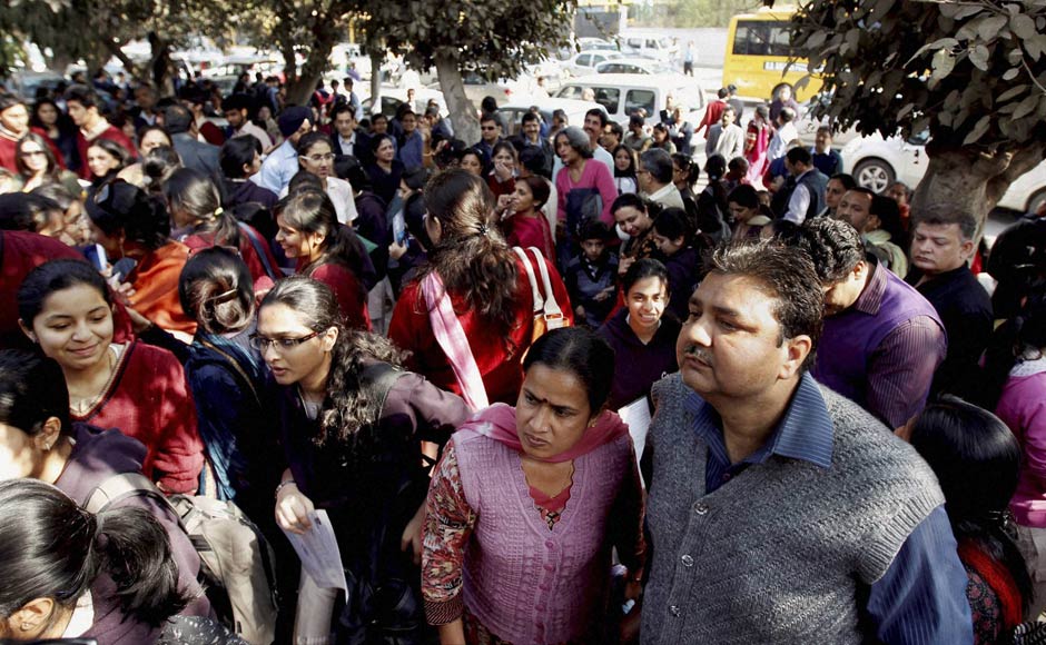 Guardians look on as students enter an examination centre to appear for the standard XII examinations of CBSE, in New Delhi on Thursday. PTI Guardians look on as students enter an examination centre to appear for the standard XII examinations of CBSE, in New Delhi on Thursday. PTI