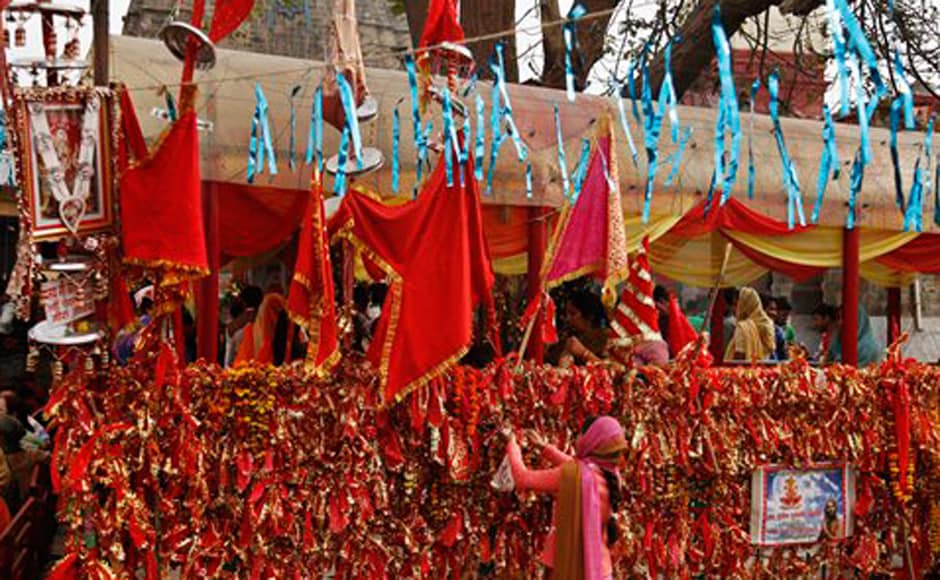 Hindu devotees tie religious piece of cloth at the historical Kali Temple on the third day of the Navratri. AP Hindu devotees tie religious piece of cloth at the historical Kali Temple on the third day of the Navratri. AP