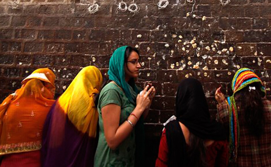 Hindu devotees pray outside the historical Kali Temple on the third day of the Navratri. AP Hindu devotees pray outside the historical Kali Temple on the third day of the Navratri. AP