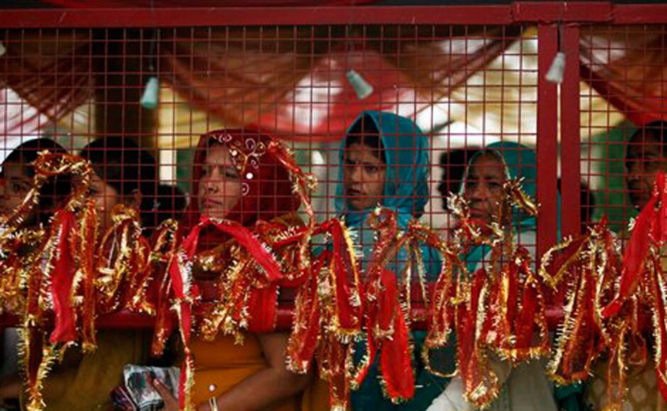 Hindu devotees stand in a queue inside the historical Kali Temple on the third day of the Navratri. AP Hindu devotees stand in a queue inside the historical Kali Temple on the third day of the Navratri. AP