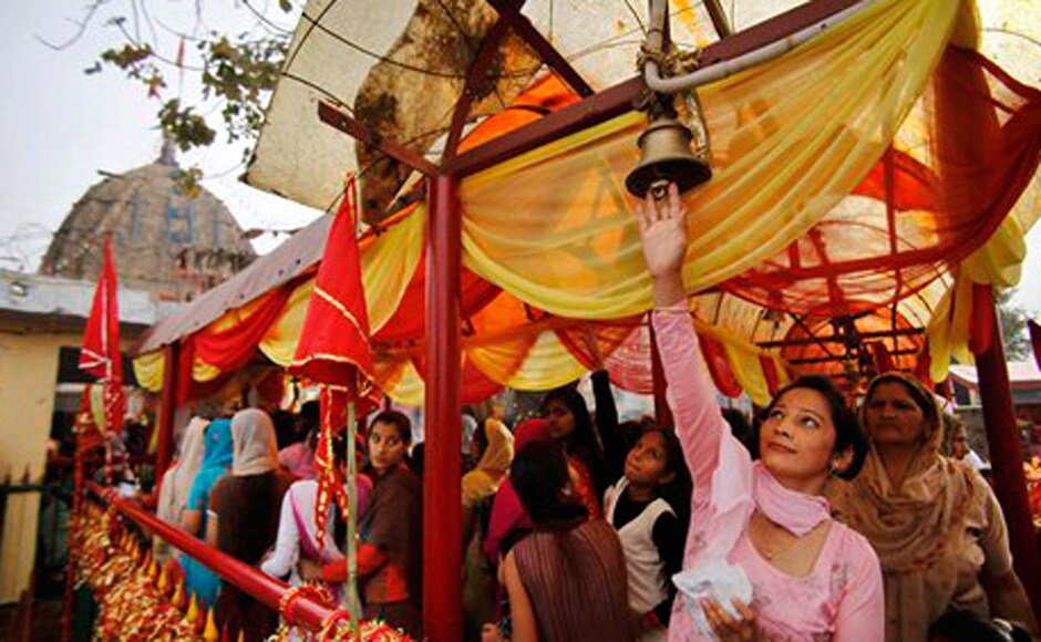 A Hindu devotee tries to ring a bell tied to a chain as other stand in a queue at the historical Kali Temple on the third day of the Navratri. AP A Hindu devotee tries to ring a bell tied to a chain as other stand in a queue at the historical Kali Temple on the third day of the Navratri. AP