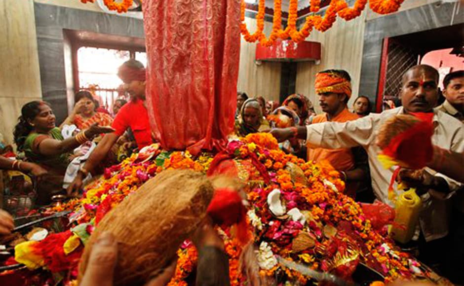 Hindu devotees offer coconuts as they pray inside the Alopi Devi temple in Allahabad. AP Hindu devotees offer coconuts as they pray inside the Alopi Devi temple in Allahabad. AP