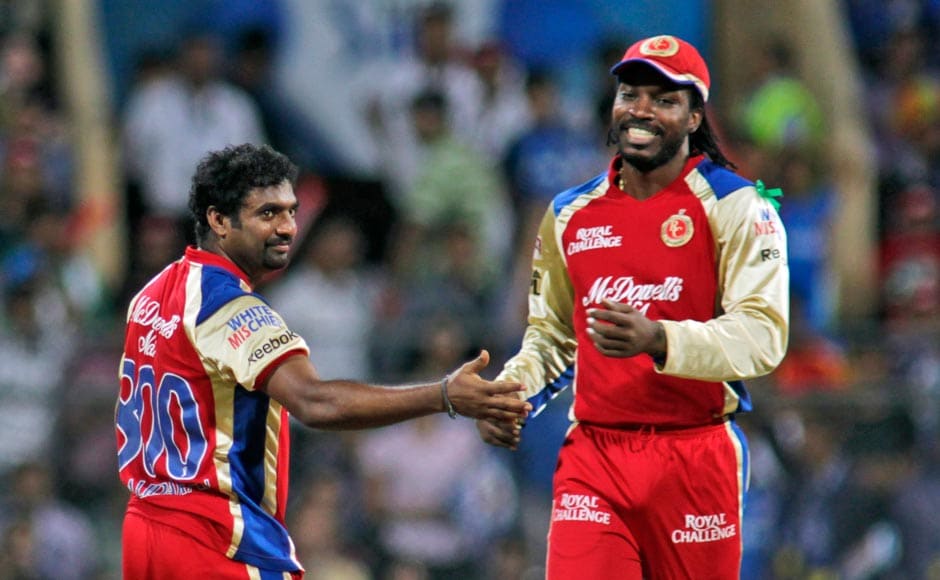 Royal Challengers Banglore's Muttiah Muralitharan, left and Chris Gayle celebrate the wicket of Mumbai Indians Dwayne Smith. AP Royal Challengers Banglore's Muttiah Muralitharan, left and Chris Gayle celebrate the wicket of Mumbai Indians Dwayne Smith. AP