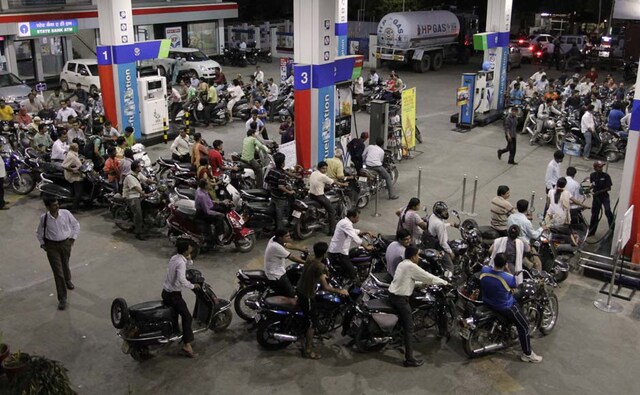 The land of bikes: Motorcyclists in Ahmedabad crowd into a petrol pump after the hike was announced. AP The land of bikes: Motorcyclists in Ahmedabad crowd into a petrol pump after the hike was announced. AP