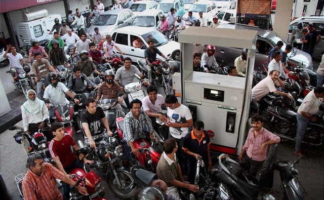 Who cares if the prices are up, I'd better look good in that photo: People line up to fill their vehicles at an oil pump after the announcement of hike in petrol prices, in Gurgaon. PTI Who cares if the prices are up, I'd better look good in that photo: People line up to fill their vehicles at an oil pump after the announcement of hike in petrol prices, in Gurgaon. PTI