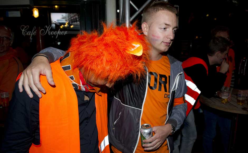 There, there the headgear is not so bad: Soccer fans react after watching the Euro 2012 soccer championship Group D match between the Netherlands and Germany outside a cafe on Leidseplein in Amsterdam, Netherlands. AP There, there the headgear is not so bad: Soccer fans react after watching the Euro 2012 soccer championship Group D match between the Netherlands and Germany outside a cafe on Leidseplein in Amsterdam, Netherlands. AP