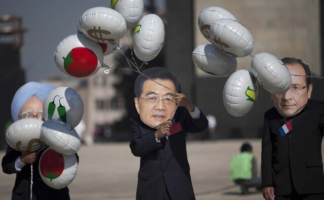 Oxfam activists wear masks depicting Prime Minister Manmohan Singh (L), Chinese President Hu Jintao (C) and French President Francois Hollande as they protest in Mexico City. Alexandre Meneghini/AP Oxfam activists wear masks depicting Prime Minister Manmohan Singh (L), Chinese President Hu Jintao (C) and French President Francois Hollande as they protest in Mexico City. Alexandre Meneghini/AP