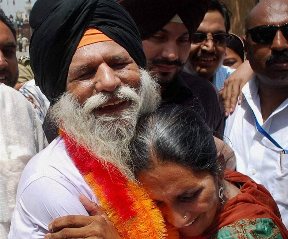 Surjit Singh hugs his daughter Parminder Kaur on his arrival at Attari-Wagah border. PTI Surjit Singh hugs his daughter Parminder Kaur on his arrival at Attari-Wagah border. PTI