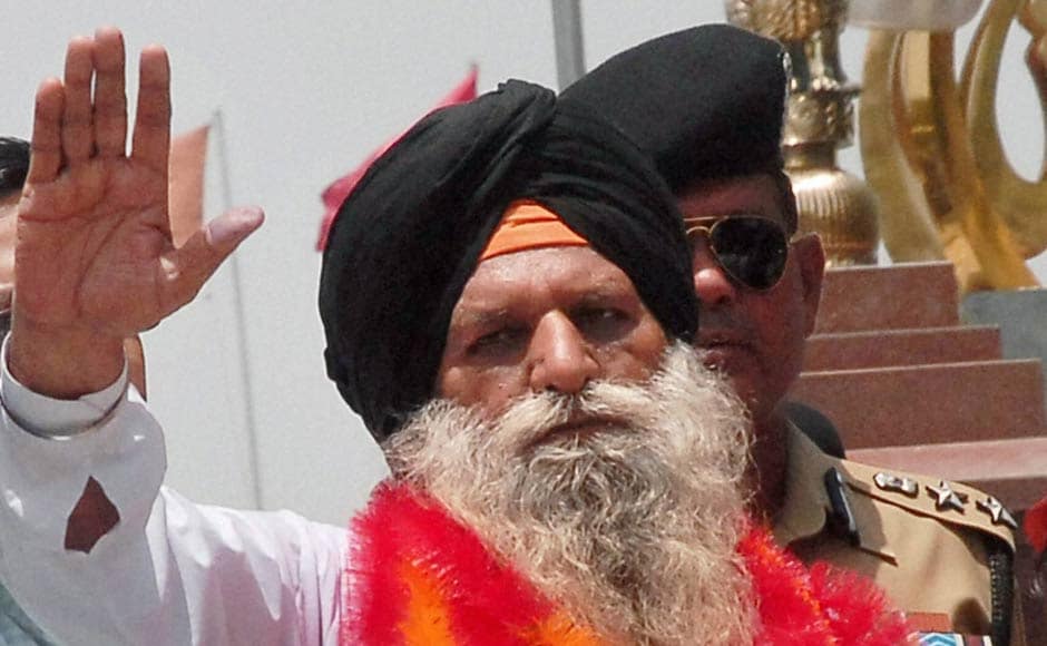 Surjit Singh waves on his arrival at the Indian side of Attari-Wagah border. PTI Surjit Singh waves on his arrival at the Indian side of Attari-Wagah border. PTI