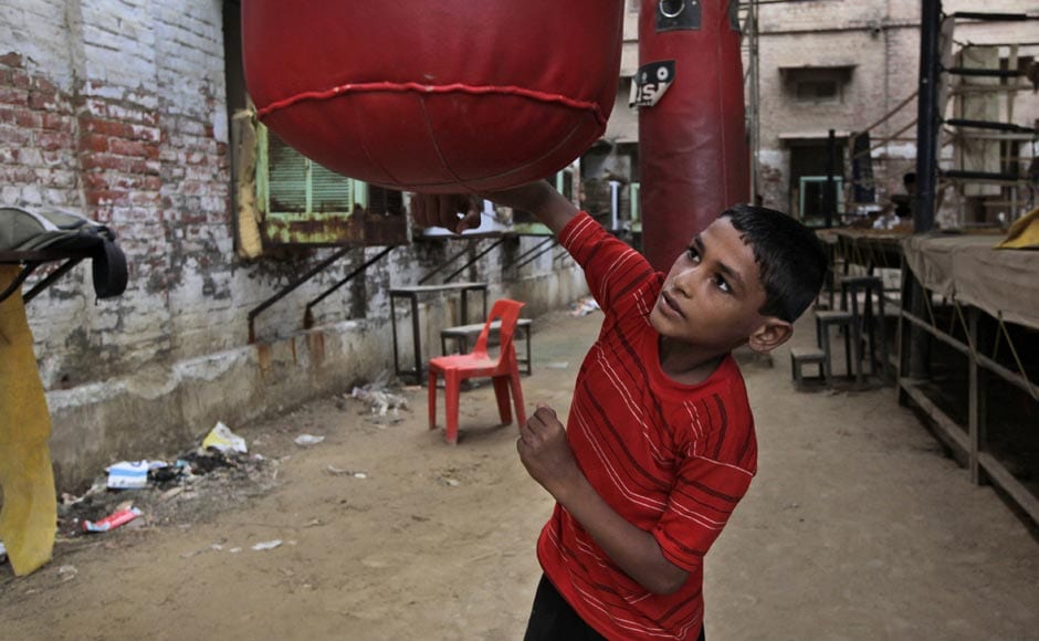 Rahul, a 10-year-old boxing trainee, practices with a punching bag at the Sports Authority of India complex in Bhiwani. AP Rahul, a 10-year-old boxing trainee, practices with a punching bag at the Sports Authority of India complex in Bhiwani. AP