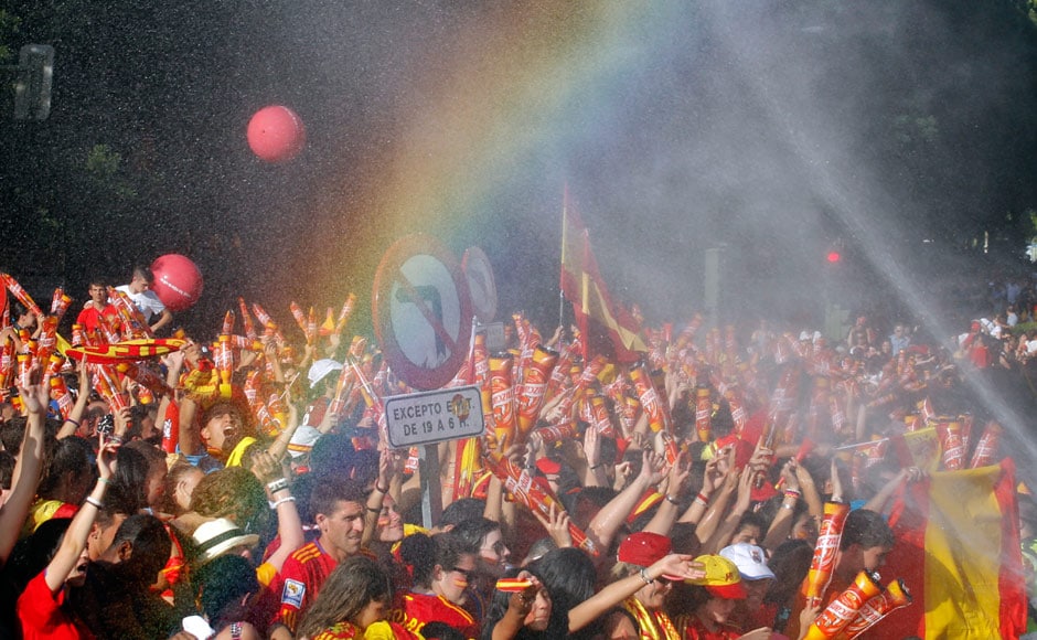 Supporters are sprayed with water as they wait for the arrival of their players to celebrate their Euro 2012 victory in downtown Madrid. Reuters Supporters are sprayed with water as they wait for the arrival of their players to celebrate their Euro 2012 victory in downtown Madrid. Reuters