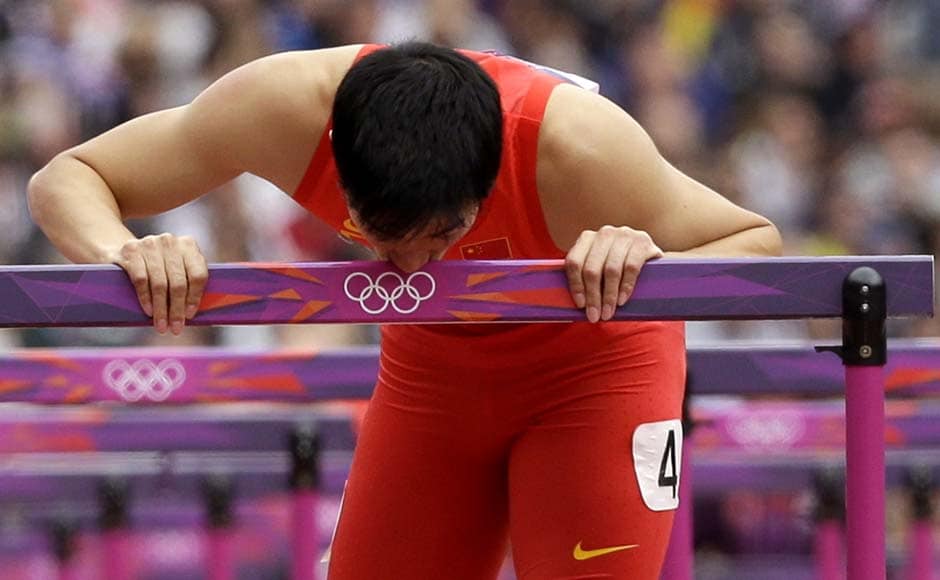 China's Liu Xiang kisses his hurdle after falling in a men's 110-meter hurdles heat during the athletics. The Chinese star athlete won the gold in the same event in 2004. His hopes were dashed by injury in 2008. AP China's Liu Xiang kisses his hurdle after falling in a men's 110-meter hurdles heat during the athletics. The Chinese star athlete won the gold in the same event in 2004. His hopes were dashed by injury in 2008. AP