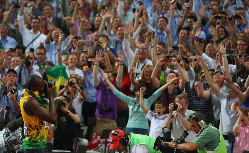 Usain Bolt takes photographs of the crowd with one of the photographers' cameras as he celebrates winning gold in the Men's 200m Final. Alexander Hassenstein/Getty Images Usain Bolt takes photographs of the crowd with one of the photographers' cameras as he celebrates winning gold in the Men's 200m Final. Alexander Hassenstein/Getty Images