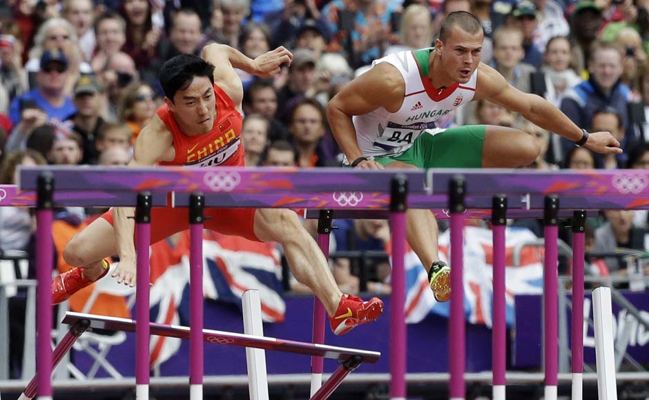 China's Liu Xiang, left, fails to clear a hurdle in a men's 110-meter hurdles heat as he competes alongside Hungary's Balazs Baji during the athletics in the Olympic Stadium. AP China's Liu Xiang, left, fails to clear a hurdle in a men's 110-meter hurdles heat as he competes alongside Hungary's Balazs Baji during the athletics in the Olympic Stadium. AP