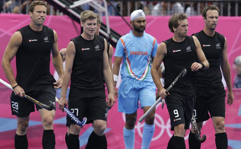 New Zealand's Richard Petherick (28), Stephen Jenness (27), Blair Hilton (9) and Ryan Archibald walk to resume the play following a goal by Phillip Burrows, unseen, during their men's hockey preliminary match against India. New Zealand won 3-1. In centre, in blue is India's Sandeep Singh. Bullit Marquez/ AP New Zealand's Richard Petherick (28), Stephen Jenness (27), Blair Hilton (9) and Ryan Archibald walk to resume the play following a goal by Phillip Burrows, unseen, during their men's hockey preliminary match against India. New Zealand won 3-1. In centre, in blue is India's Sandeep Singh. Bullit Marquez/ AP
