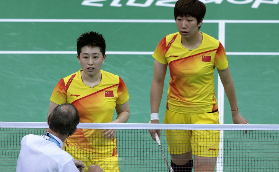 An unidentified official talks to world doubles champions Yu Yang, left, and Wang Xiaoli, as South Korea's Jung Kyung-eun, right, and Kim Ha-na, listen during their women's doubles badminton match at the 2012 Summer Olympics. AP An unidentified official talks to world doubles champions Yu Yang, left, and Wang Xiaoli, as South Korea's Jung Kyung-eun, right, and Kim Ha-na, listen during their women's doubles badminton match at the 2012 Summer Olympics. AP