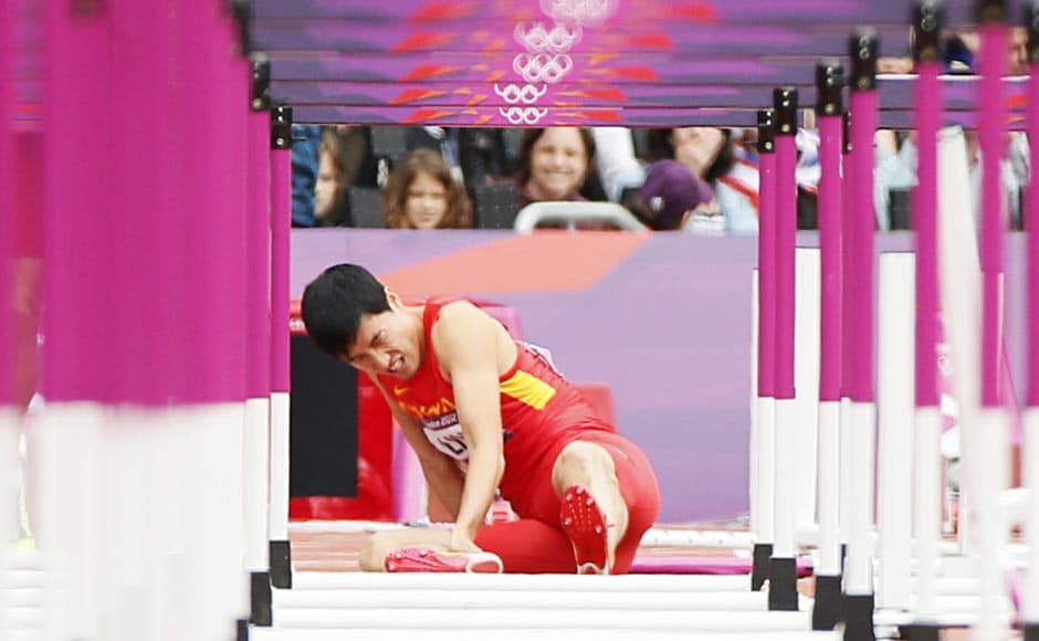 China's Liu Xiang sits on the track after suffering an injury in his men's 110m hurdles round 1 heat. Reuters China's Liu Xiang sits on the track after suffering an injury in his men's 110m hurdles round 1 heat. Reuters