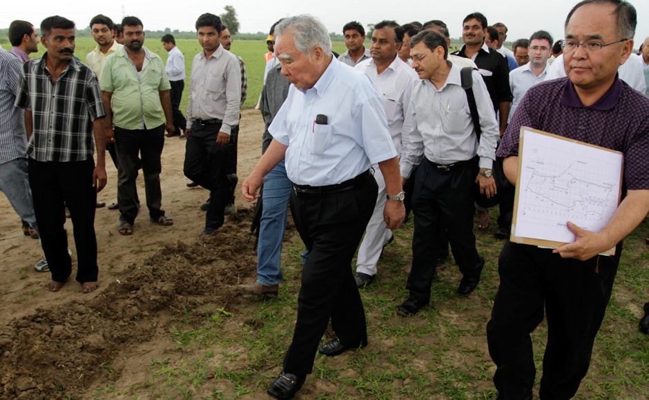 Suzuki, center, inspects the proposed site where the motor company will build a new manufacturing facility in Gujarat by 2015-16. AP Suzuki, center, inspects the proposed site where the motor company will build a new manufacturing facility in Gujarat by 2015-16. AP
