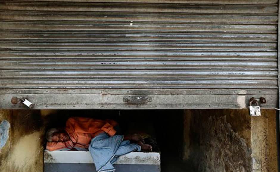 A man rests in a shop with shutters half closed during a nationwide strike in New Delhi. AP A man rests in a shop with shutters half closed during a nationwide strike in New Delhi. AP
