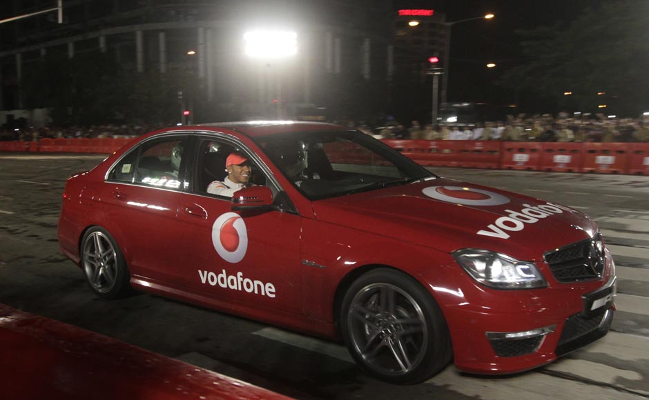 British Formula One driver Lewis Hamilton, drives a car with the winner of Vodafone Speed Fest, a promotional event in Mumbai. Rajanish Kakade/AP British Formula One driver Lewis Hamilton, drives a car with the winner of Vodafone Speed Fest, a promotional event in Mumbai. Rajanish Kakade/AP