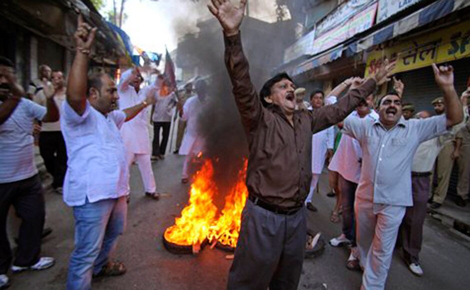 BJP activists shout slogans as they burn tires during a nationwide strike in Jammu. AP BJP activists shout slogans as they burn tires during a nationwide strike in Jammu. AP