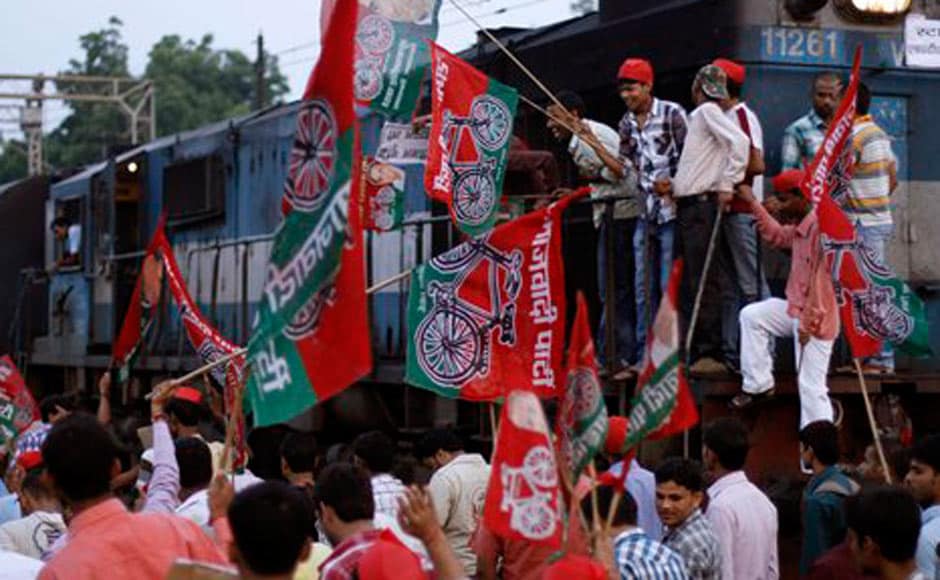 Samajwadi Party activists hold party flags and block a railway track during a protest in Allahabad. AP Samajwadi Party activists hold party flags and block a railway track during a protest in Allahabad. AP