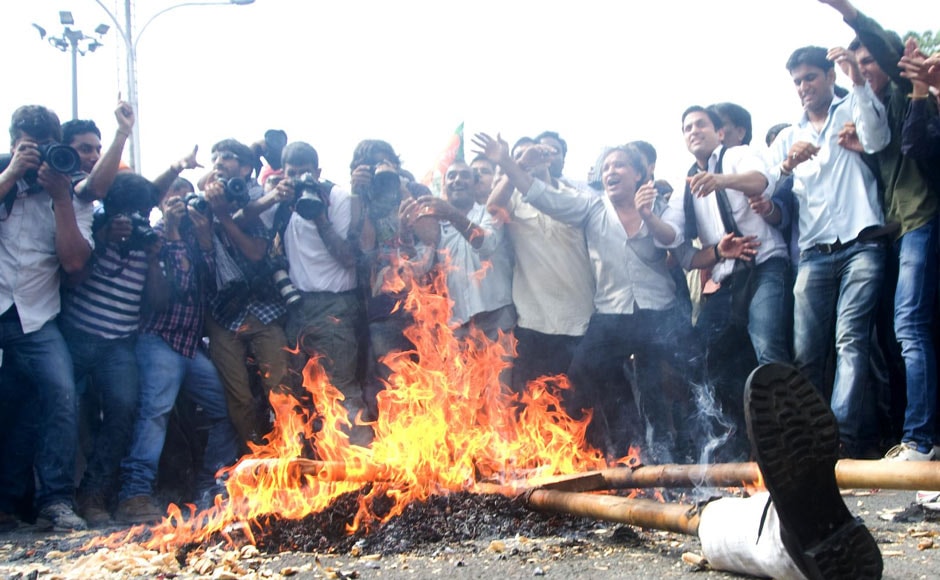 Protestors burn effigies representing Prime Minister Manmohan Singh in New Delhi. Naresh Sharma/ Firstpost Protestors burn effigies representing Prime Minister Manmohan Singh in New Delhi. Naresh Sharma/ Firstpost