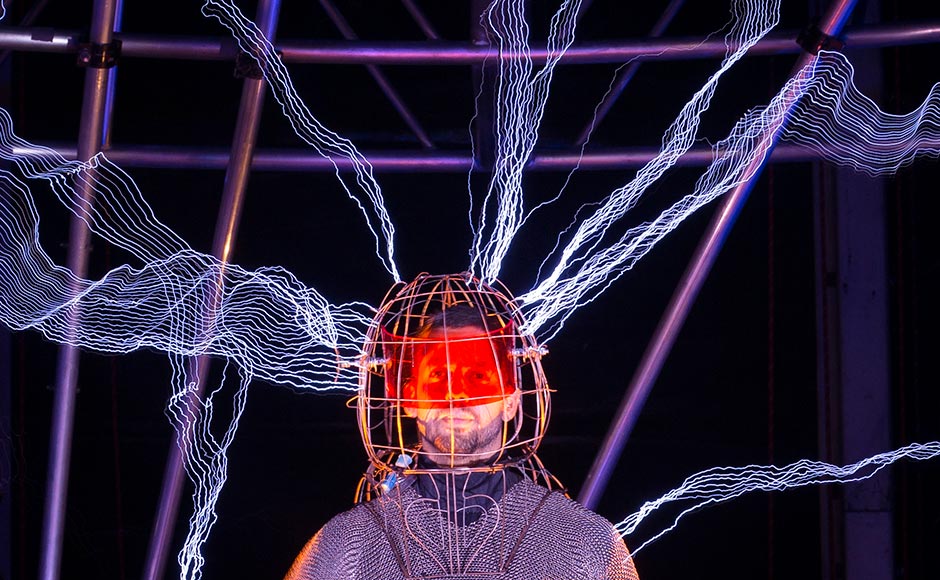 Magician David Blaine stands inside an apparatus surrounded by a million volts of electric currents streamed by tesla coils during his 72-hour "Electrified: 1 Million Volts Always On" stunt on Pier 54, New York. John Minchillo/AP Magician David Blaine stands inside an apparatus surrounded by a million volts of electric currents streamed by tesla coils during his 72-hour "Electrified: 1 Million Volts Always On" stunt on Pier 54, New York. John Minchillo/AP