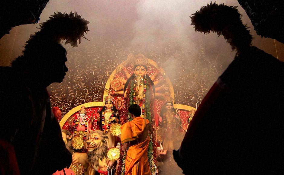 Devotees offering "Sandhya Aarti " in front of Devi Durga during Mahashtami in Kolkata. PTI Devotees offering "Sandhya Aarti " in front of Devi Durga during Mahashtami in Kolkata. PTI