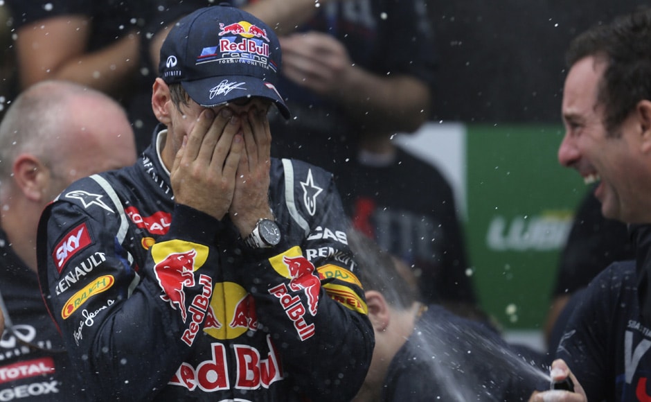 Champagne sprayed on Vettel as he celebrates winning the world championship. Reuters Champagne sprayed on Vettel as he celebrates winning the world championship. Reuters