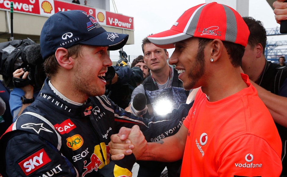 McLaren Formula One driver Lewis Hamilton of Britain (R) with Red Bull driver Sebastian Vettel of Germany after the Brazilian F1 Grand Prix at Interlagos circuit in Sao Paulo. Vettel became Formula One's youngest triple world champion at the age of 25 at the Brazilian Grand Prix on Sunday. Reuters McLaren Formula One driver Lewis Hamilton of Britain (R) with Red Bull driver Sebastian Vettel of Germany after the Brazilian F1 Grand Prix at Interlagos circuit in Sao Paulo. Vettel became Formula One's youngest triple world champion at the age of 25 at the Brazilian Grand Prix on Sunday. Reuters