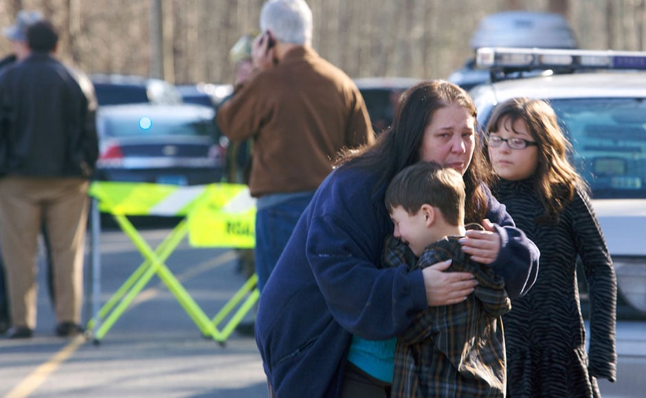 A young boy is comforted after the tragic shootout in the elementary school in Connecticut in which 27 people, including 18 children, were killed. Reuters. A young boy is comforted after the tragic shootout in the elementary school in Connecticut in which 27 people, including 18 children, were killed. Reuters.