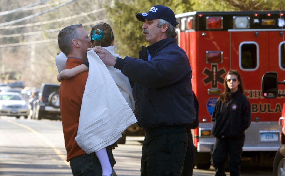 A young girl is handed over to her parent by a rescue operation worker after the shootout in the Sandy Hook Elementary School in Newtown, Connecticut, northeast of New York City. Reuters. A young girl is handed over to her parent by a rescue operation worker after the shootout in the Sandy Hook Elementary School in Newtown, Connecticut, northeast of New York City. Reuters.