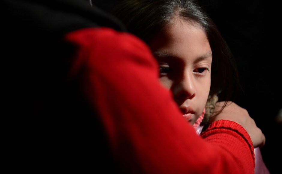 A girl is being comforted by her parents during a memorial service that was organised in the St Rose Church following the shooting in an elementary school in Newtown, Connecticut. AFP A girl is being comforted by her parents during a memorial service that was organised in the St Rose Church following the shooting in an elementary school in Newtown, Connecticut. AFP