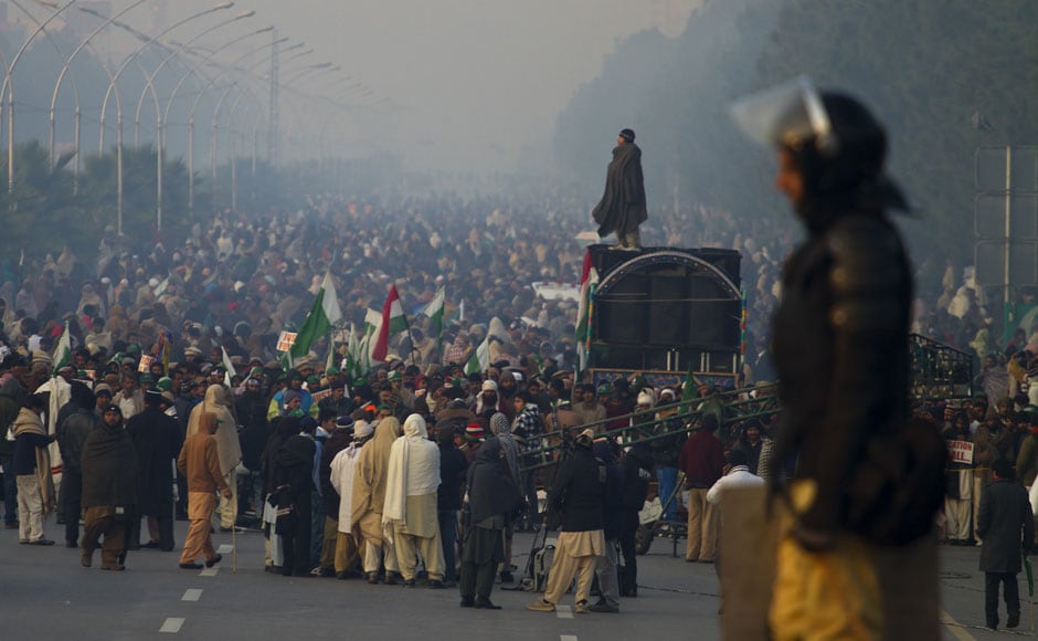 A police officer stands guard while supporters of Tahir-ul-Qadri participate in an anti government rally in Islamabad on Tuesday. AP A police officer stands guard while supporters of Tahir-ul-Qadri participate in an anti government rally in Islamabad on Tuesday. AP