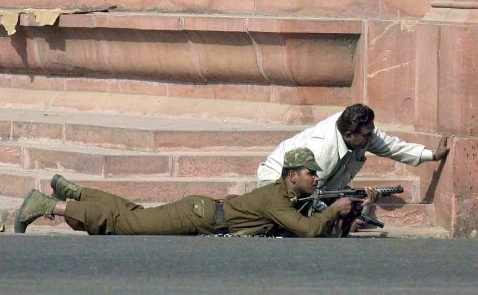 A commando takes-up position besides a plain clothed policeman near Parliament building in New Delhi on 13 December , 2001. A suicide squad stormed India's parliament complex , killing at least six people in an unprecedented attack on the seat of power of the world's biggest democracy. Reuters A commando takes-up position besides a plain clothed policeman near Parliament building in New Delhi on 13 December , 2001. A suicide squad stormed India's parliament complex , killing at least six people in an unprecedented attack on the seat of power of the world's biggest democracy. Reuters