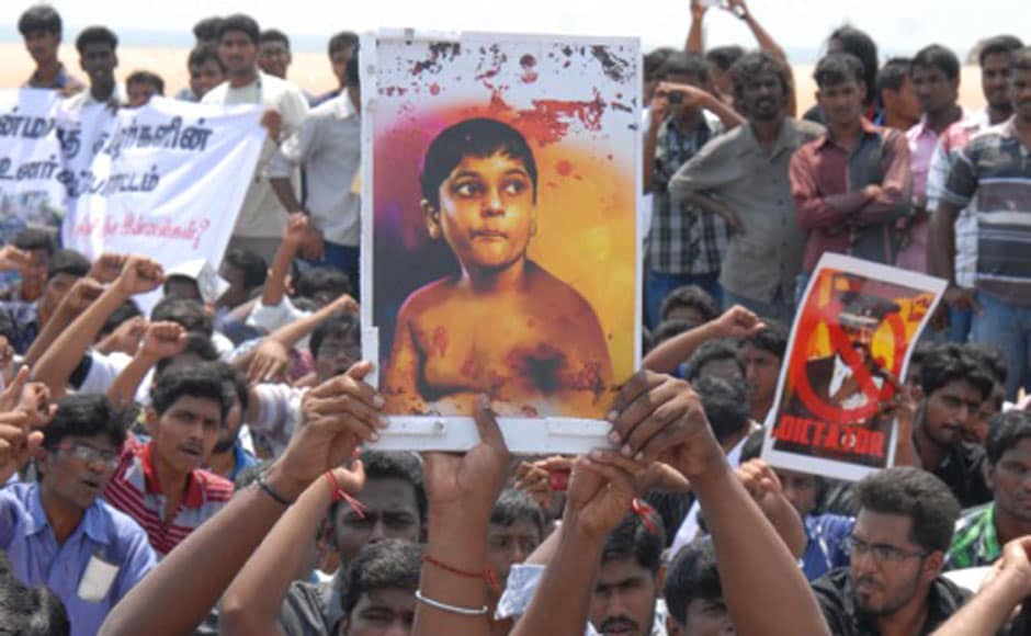 Protesting students hold up a photograph of V Prabhakaran's son Balachandran. Firstpost
