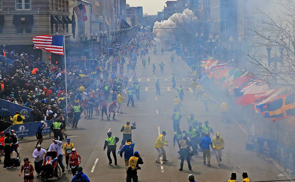 People react as the first bomb goes off near the finish line of the 2013 Boston Marathon on Monday, April 15, 2013. AP Photo/The Boston Globe, David L Ryan People react as the first bomb goes off near the finish line of the 2013 Boston Marathon on Monday, April 15, 2013. AP Photo/The Boston Globe, David L Ryan